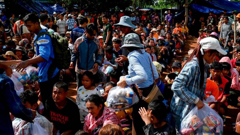 People who fled their homes near the border between Cambodia and Thailand gather at a food distribution site on the grounds of a pagoda in Oddar Meanchey province on July 28, 2025. - AFPPix