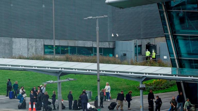 People wait outside Dublin Airport’s Terminal 2 which has been evacuated as a safety precaution, in Dublin, Ireland, September 20, 2025. REUTERS/Clodagh Kilcoyne