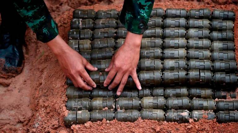 For representational purposes only - A soldier stacks anti-personnel mines before a controlled detonation at the official Destruction Ceremony of Thailand’s Retained Anti-Personnel Mines 2019 event by the Royal Thai Armed Forces in the western Thai province of Sa Kaeo on Aug 6, 2019. — AFP