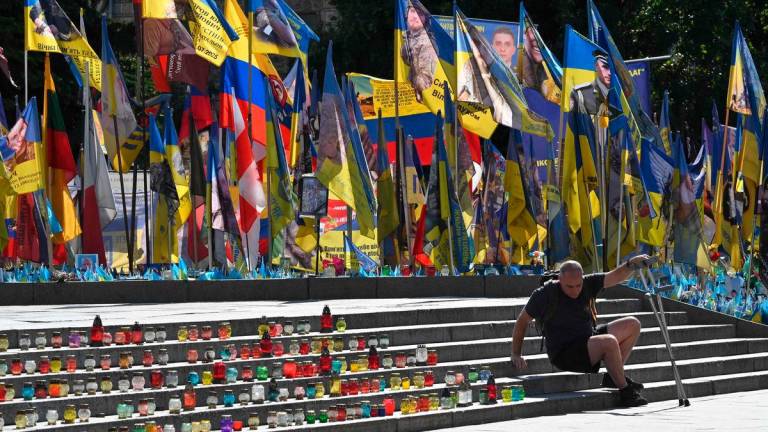 For representational purposes only: A wounded Ukrainian serviceman is seen at a makeshift memorial for fallen Ukrainian and foreign soldiers on Independence Square in Kyiv on September 13, 2025, amid Russian invasion in Ukraine. (Photo by Sergei SUPINSKY / AFP)