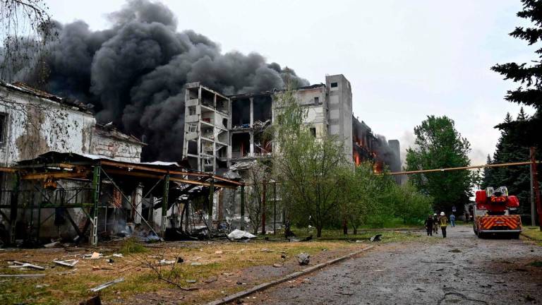 Firefighters extinguish a fire at a civilian plant following Russian powerful attacks to Ukrainian city of Kharkiv early on June 7, 2025. AFPPIX