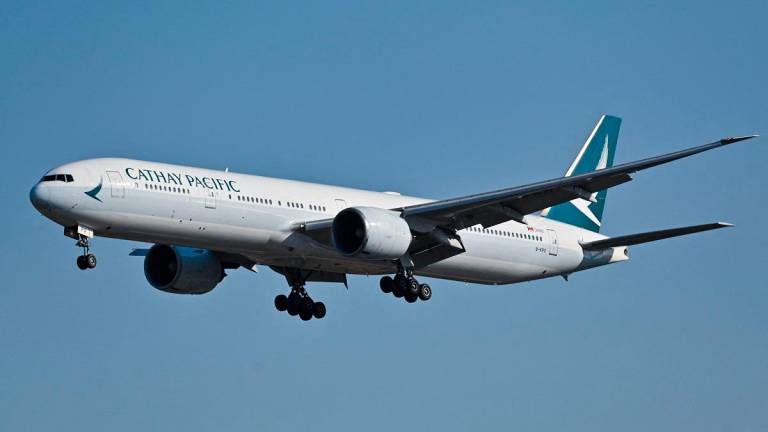 (FILES) A Cathay Pacific Boeing 777-300ER aircraft. - ADEK BERRY / AFP