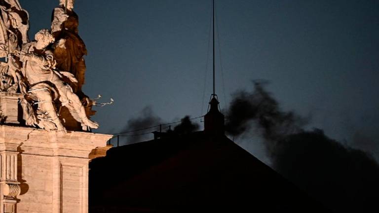 This photograph shows black smoke rising from the chimney of the Sistine Chapel signalling that cardinals failed to elect a new pope in the first ballot of their conclave in the Vatican on May 7, 2025. - Filippo MONTEFORTE / AFP