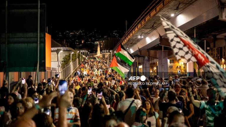 People march during a procession from the Music For Peace humanitarian organization headquarters to the nearby harbor where four boat are waiting to leave for Gaza joining the “Global Sumud Flotilla”, on August 30, 2025. (Photo by Federico SCOPPA / AFP)
