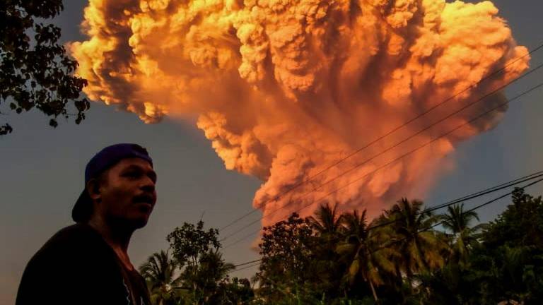 A villager watches the eruption of Mount Lewotobi Laki-Laki as seen from Talibura village in Sikka, East Nusa Tenggara, on June 17, 2025. (Photo by AFP)