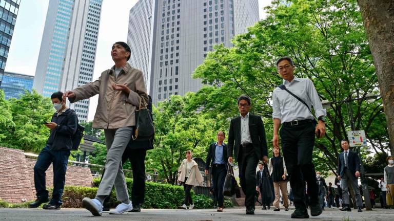 Office workers make their way from the Shinjuku Station as they commute to work in central Tokyo on May 16, 2025. Japan’s economy contracted 0.2 percent in the three months to March, registering the first quarterly drop in a year, according to cabinet office data released on May 16. AFPpix