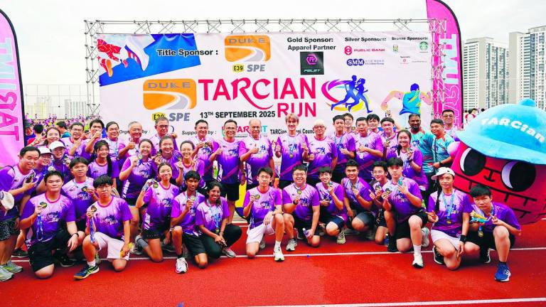 TARCian community of alumni, staff, and students on TAR UMT Arena’s rooftop track and field after completing TARCian Run 2025.