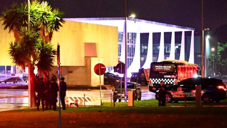 Police vehicles are seen in front of the Brazilian Supreme Court after explosions in the Three Powers Square in Brasilia - REUTERSpix