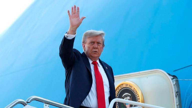 U.S. President Donald Trump boards Air Force One as he departs for Alaska to meet with Russian President Vladimir Putin to negotiate for an end to the war in Ukraine, from Joint Base Andrews in Maryland, U.S., August 15, 2025. REUTERS/Kevin Lamarque