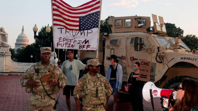 Protesters confront members of the National Guard patrolling Union Station, after U.S. President Donald Trump deployed the National Guard and ordered an increased presence of federal law enforcement to assist in crime prevention, with the U.S. Capitol building in the background, in Washington, D.C., U.S., August 16, 2025. - REUTERSPIX