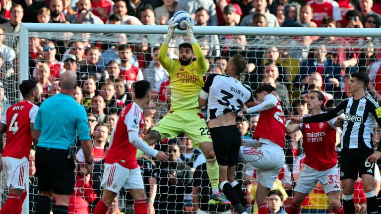 Arsenal's Spanish goalkeeper #22 David Raya catched the ball during the English Premier League football match between Arsenal and Newcastle United at the Emirates Stadium in London on May 18, 2025. - AFPPIX