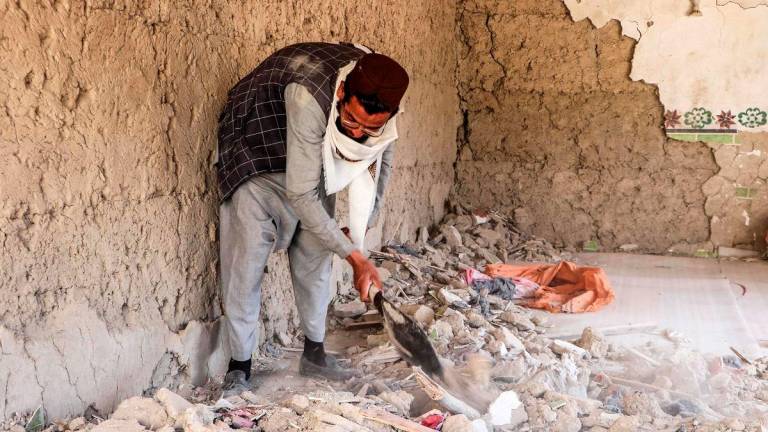 An Afghan resident clears the remains of a damaged house in the aftermath of aerial strikes by Pakistan in Urgun district at Paktika province on October 18, 2025. - AFPpix