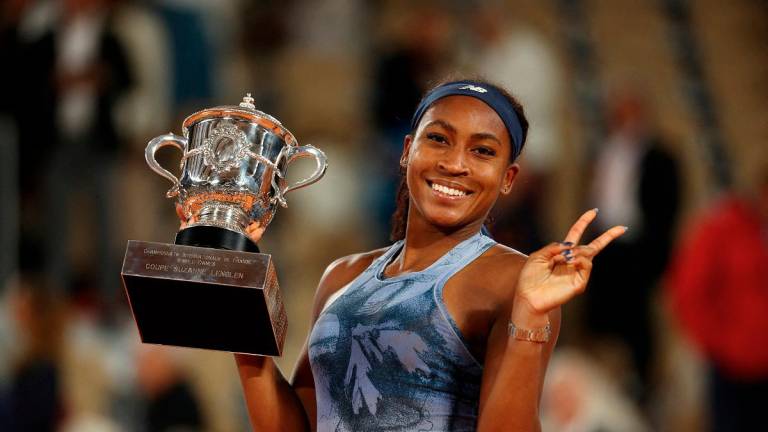 Coco Gauff of the U.S. celebrates with the trophy after winning the women’s singles final against Belarus’ Aryna Sabalenka - REUTERS