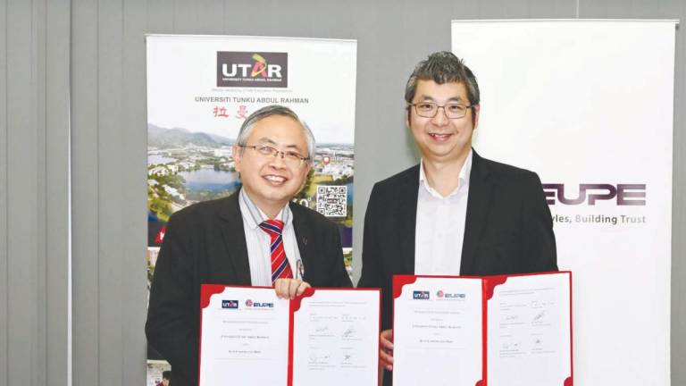 Ewe (left) and Tan after the MoU signing event.