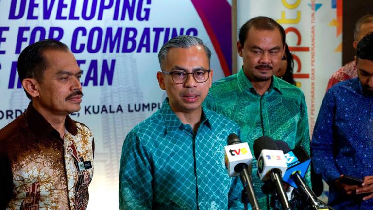 Minister of Communications, Datuk Fahmi Fadzil, during a press conference after officiating the “Seminar on Developing Training Module for Combating Fake News in ASEAN 2025” today. Also present were the Secretary-General of the Ministry of Communications, Datuk Mohamad Fauzi Md Isa, and the Director-General of the Tun Abdul Razak Institute of Broadcasting and Information (IPPTAR), Roslan Ariffin. – BERNAMA
