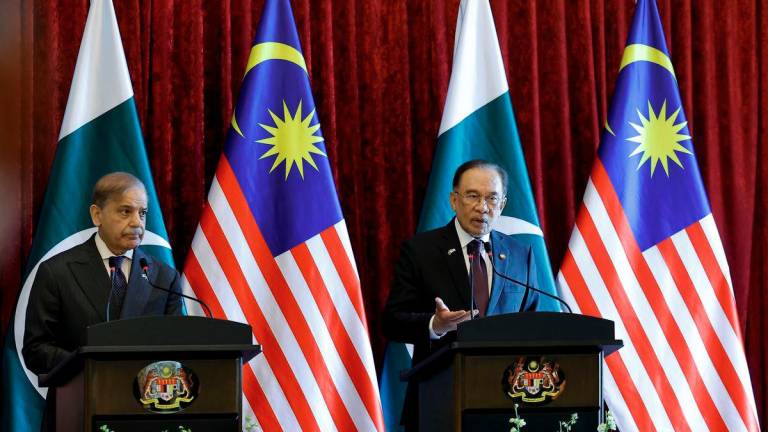 Prime Minister Datuk Seri Anwar Ibrahim during a joint press conference with Pakistan Prime Minister Muhammad Shehbaz Sharif (left) at the Perdana Putra Building today. - BERNAMA