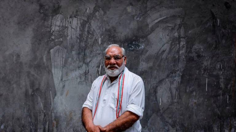 Rashid Ahmed, 60, an electric rickshaw driver and look-alike of Indian Prime Minister Narendra Modi - REUTERSpix