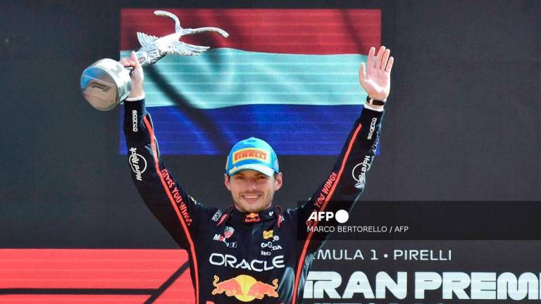 Red Bull Racing's Dutch driver Max Verstappen celebrates his victory on the podium after winning the Italian Formula One Grand Prix at the Autodromo Nazionale Monza circuit, in Monza, northern Italy, on September 7, 2025. - AFP