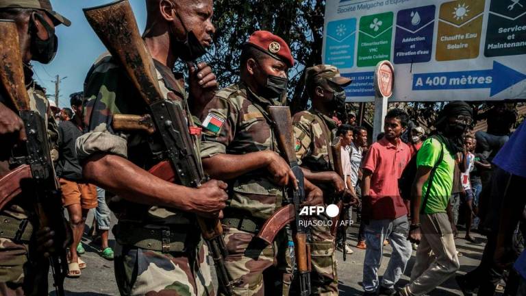 Members of a Madagascar army contingent stand in a road near their camp near Antananarivo on October 11, 2025. - AFP
