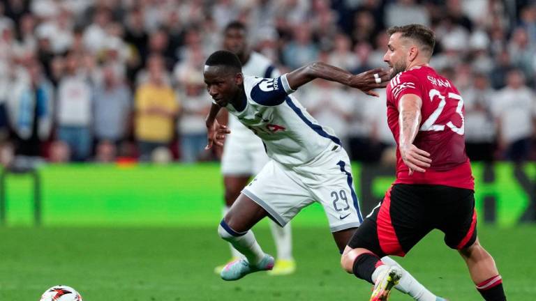 Tottenham Hotspur's Senegalese forward #29 Pape Matar Sarr and Manchester United's English defender #23 Luke Shaw vie for the ball during the UEFA Europa League final football match between Tottenham Hotspur and Manchester United at San Mames stadium in Bilbao on May 21, 2025. - AFPPIX