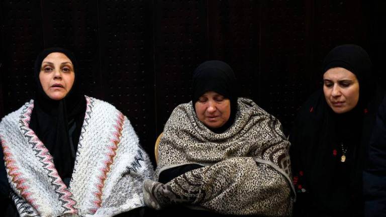 Palestinian families react after Israel delayed the release of Palestinian prisoners, scheduled to be released in the seventh hostage-prisoner exchange - AFPpix