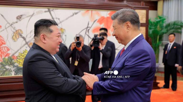 This picture taken on September 4, 2025 and released from North Korea's official Korean Central News Agency (KCNA) on September 5, 2025 shows North Korean leader Kim Jong Un (L) shaking hands with Chinese President Xi Jinping in Beijing. - Photo by KCNA VIA KNS / AFP