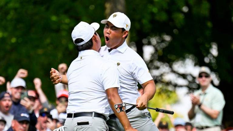 Si Woo Kim (left) and Tom Kim celebrating during the Four-ball session at the Presidents Cup on Saturday. Credit Getty Images