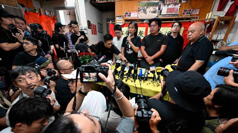 League of Social Democrats leader Chan Po-ying (C) speaks at a press conference at their headquarters in Hong Kong on June 29, 2025. (Photo by Peter PARKS / AFP)