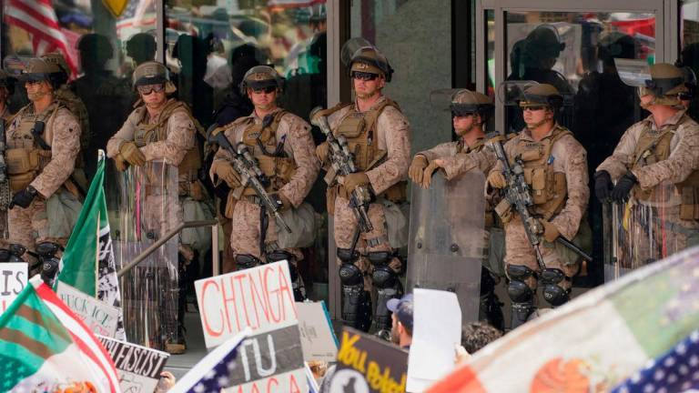 U.S. Marines stand watch as people protest against U.S. President Donald Trump’s policies and federal immigration sweeps during a No Kings Day demonstration in Los Angeles, California, U.S., June 14, 2025. REUTERSpix