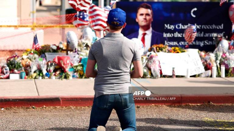 A man mourns Turning Point USA founder Charlie Kirk at a memorial set up outside of the Turning Point USA headquarters on September 12, 2025 in Phoenix, Arizona. US President Donald Trump on Friday announced that the suspect had been taken into custody over the killing of right-wing activist Charlie Kirk after a massive manhunt.