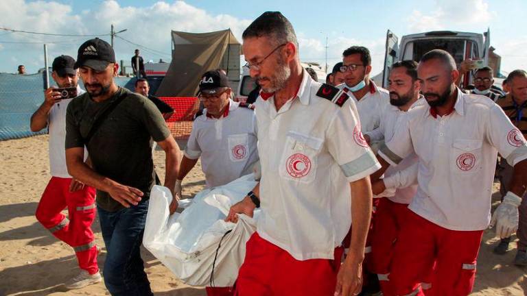 Members of Palestine Red Crescent Society (PRCS) carry the bodies of their two fellow paramedics, who according to medics, were killed when an ambulance on a mission to rescue people was hit in an Israeli strike, during their funeral in Rafah in the southern Gaza Strip, May 30, 2024. - REUTERSPIX