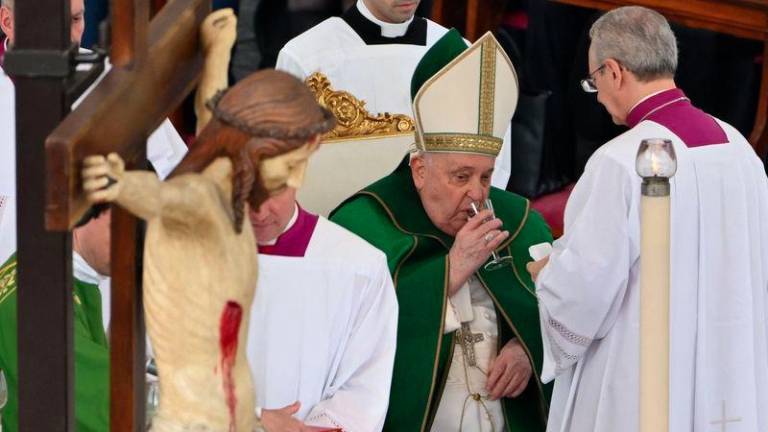 Pope Francis drinks as he celebrates a mass for the Jubilee of the Armed Forces at St. Peter's square in the Vatican on February 9, 2025. - AFPPIX