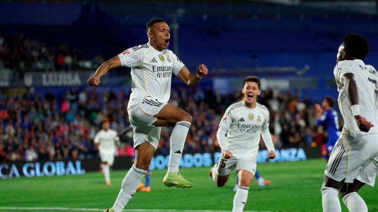 Real Madrid’s French forward #10 Kylian Mbappe celebrates scoring his team’s first goal during the Spanish league football match between Getafe CF and Real Madrid CF at Coliseum Alfonso Perez Stadium. - Thomas COEX / AFP