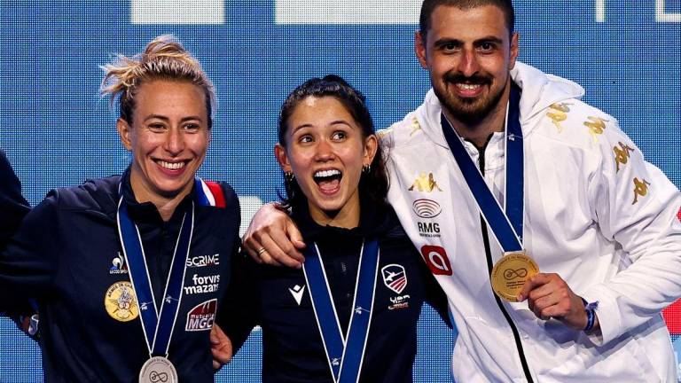 Silver medallist France’s Pauline Ranvier, gold medallist US Lee Kiefer and gold medallist Georgia’s Sandro Bazadze celebrate after medal ceremonies for the women’s foil individual competition and the men’s sabre individual competition at the FIE Fencing World Championships in Tbilisi on July 25, 2025. Photo by Giorgi ARJEVANIDZE / AFP