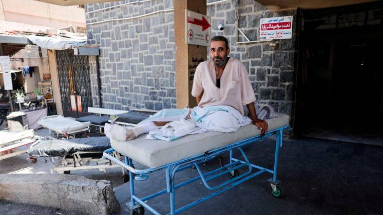 A man sits on a stretcher outside a hospital, following deadly clashes between Druze fighters, Sunni Bedouin tribes and government forces, in Syria's predominantly Druze city of Sweida, Syria July 25, 2025. - REUTERSPIX