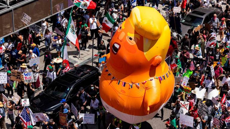 A 20-foot (6m)-tall balloon of US President Donald Trump in a diaper is seen among people taking part in a “No Kings” protest in Los Angeles, AFPpix