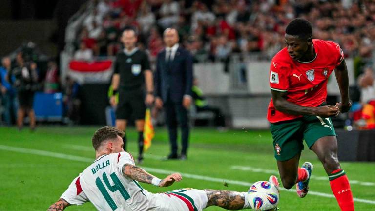 Hungary's defender #14 Bendeguz Bolla (L) and Portugal's defender #19 Nuno Mendes vie for the ball during the 2026 World Cup qualifiers Europe zone group F football match between Hungary and Portugal on September 9, 2025 in Budapest, Hungary. - AFPPIX