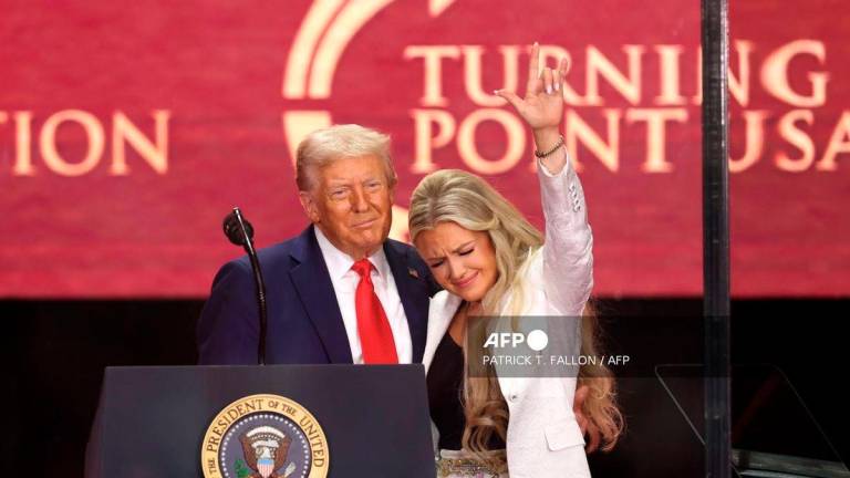 US President Donald Trump and Erika Kirk, Charlie Kirk's widow, gesture during the public memorial service for right-wing activist Charlie Kirk at State Farm Stadium in Glendale, Arizona, on September 21, 2025. - AFP