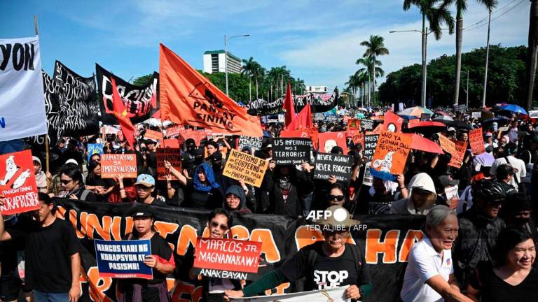 Protesters take part in a rally as they demonstrate against phony flood control projects, one of the country's biggest corruption scandals in decades, in Manila on September 21, 2025. - AFP