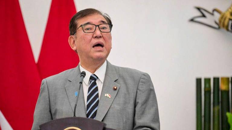 Japan's Prime Minister Shigeru Ishiba and Indonesia's President Prabowo Subianto (not pictured) give a press statement following their meeting at the presidential palace in Bogor, West Java, on January 11, 2025. - AFPPIX