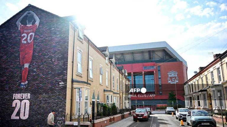 A new mural is seen on the end of a street of terraced houses, dedicated to the Portugese footballer who died in a car crash last month, created by artist Murwalls adjacent to Anfield stadium in Liverpool, north west England, on August 11, 2025. - AFP