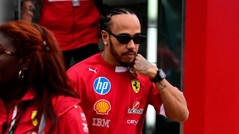 Ferrari’s British driver Lewis Hamilton in the paddock ahead of the third practice session for the Formula One British Grand Prix at the Silverstone motor racing circuit in Silverstone, central England, on July 5, 2025 - AFP