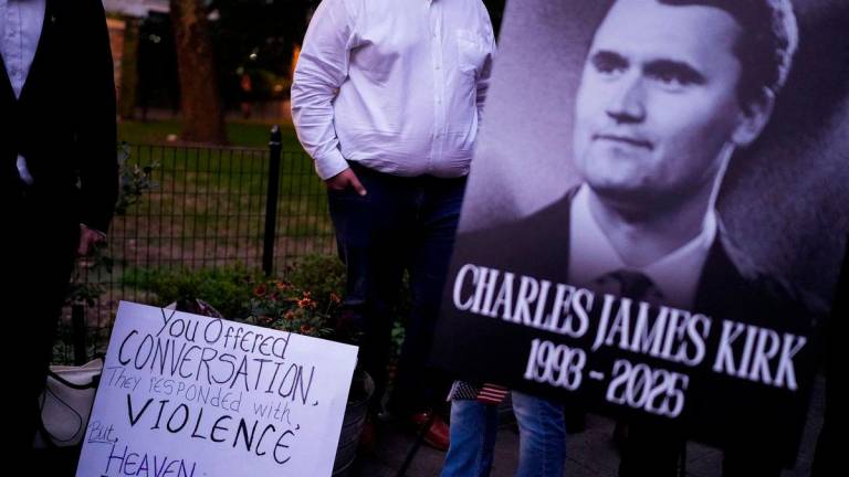 People gather during a vigil for U.S. right-wing activist and commentator Charlie Kirk, who was fatally shot while speaking at an outdoor event at Utah Valley University, at Madison Square Park in New York City, U.S., September 12, 2025. REUTERS/Adam Gray