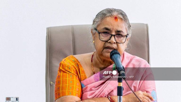 Newly-elected Prime Minister of Nepal’s interim government Sushila Karki speaks with officials at the prime minister’s office in Kathmandu on September 14, 2025. (Photo by PRABIN RANABHAT / AFP)