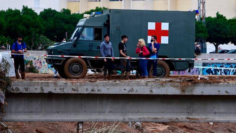 A military vehicle goes past people in Paiporta, in the region of Valencia - AFPpix