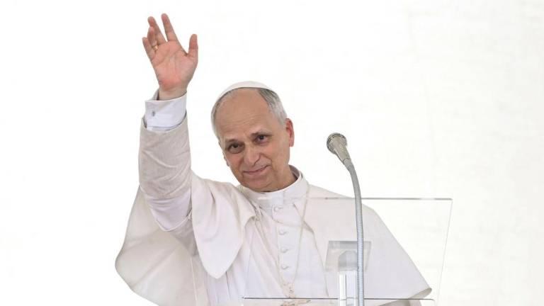 Pope Leo XIV waves as he addresses the crowd for the Angelus prayer in The Vatican on June 15, 2025. (Photo by Filippo MONTEFORTE / AFP)
