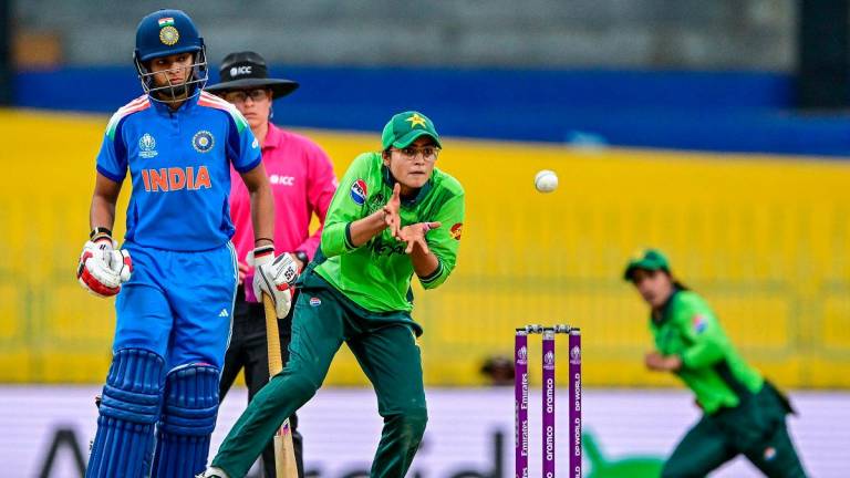 Pakistan’s Rameen Shamim (R) collects the ball as India’s Pratika Rawal watches during the ICC Women’s Cricket World Cup 2025. - S. KODIKARA / AFP
