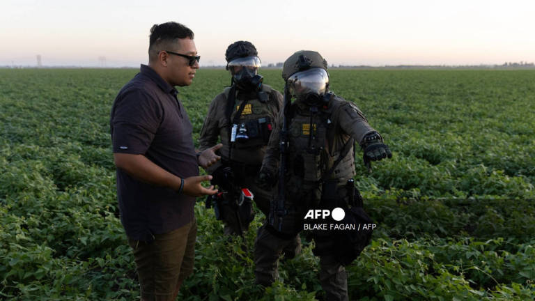 US Customs and Border Protection officers warn a protester that he will be arrested if he does not move back during a demonstration against federal immigration raids at Glass House Farms in Camarillo, California, July 10, 2025. - BERNAMA