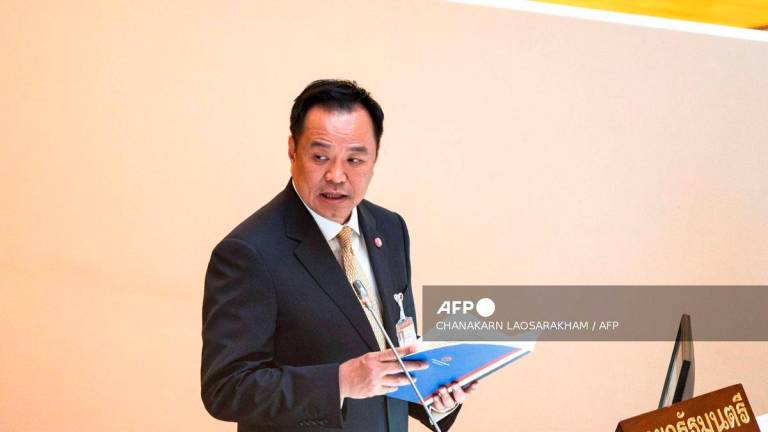 Thailand’s Prime Minister Anutin Charnvirakul arrives to deliver the cabinet policy speech at the parliament chamber in Bangkok on September 29, 2025. (Photo by Chanakarn Laosarakham / AFP)