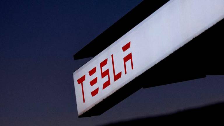 FILE PHOTO: A view of Tesla logo at an electric vehicle charging station between Los Angeles and Las Vegas in Baker, California. FILEpix - REUTERSpix